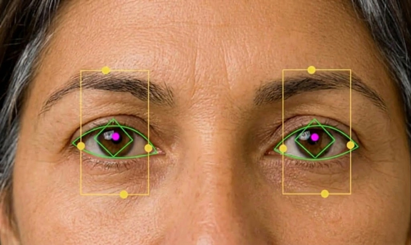 Executive-age member seated comfortably during gaze assessment on iPad in a premium clinic