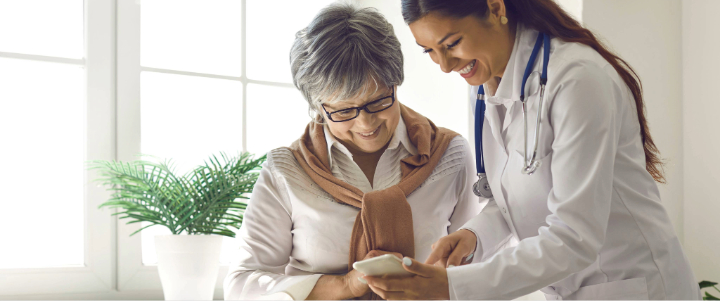 Private concierge practice with physician and executive-age patient reviewing data together